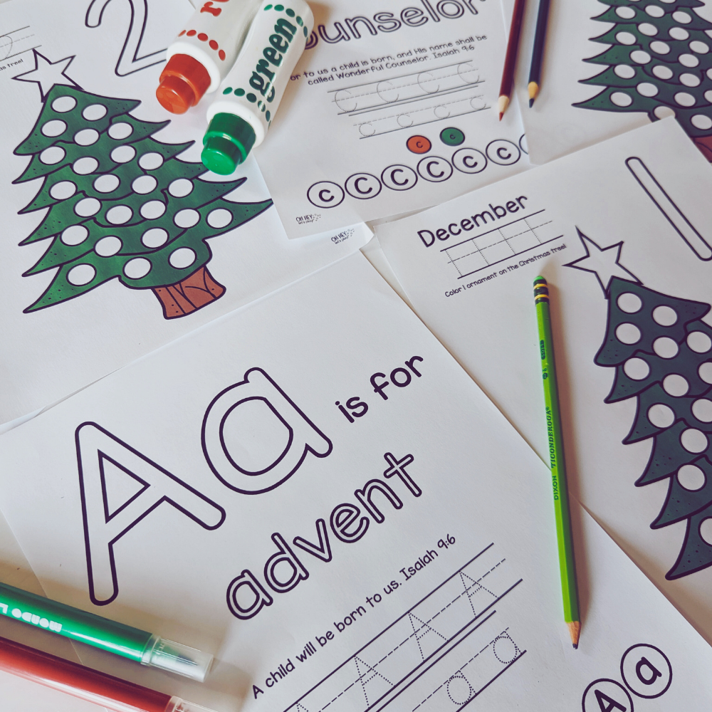 Pages from the Advent ABCs countdown to Christmas are displayed with dot markers and colored pencils.