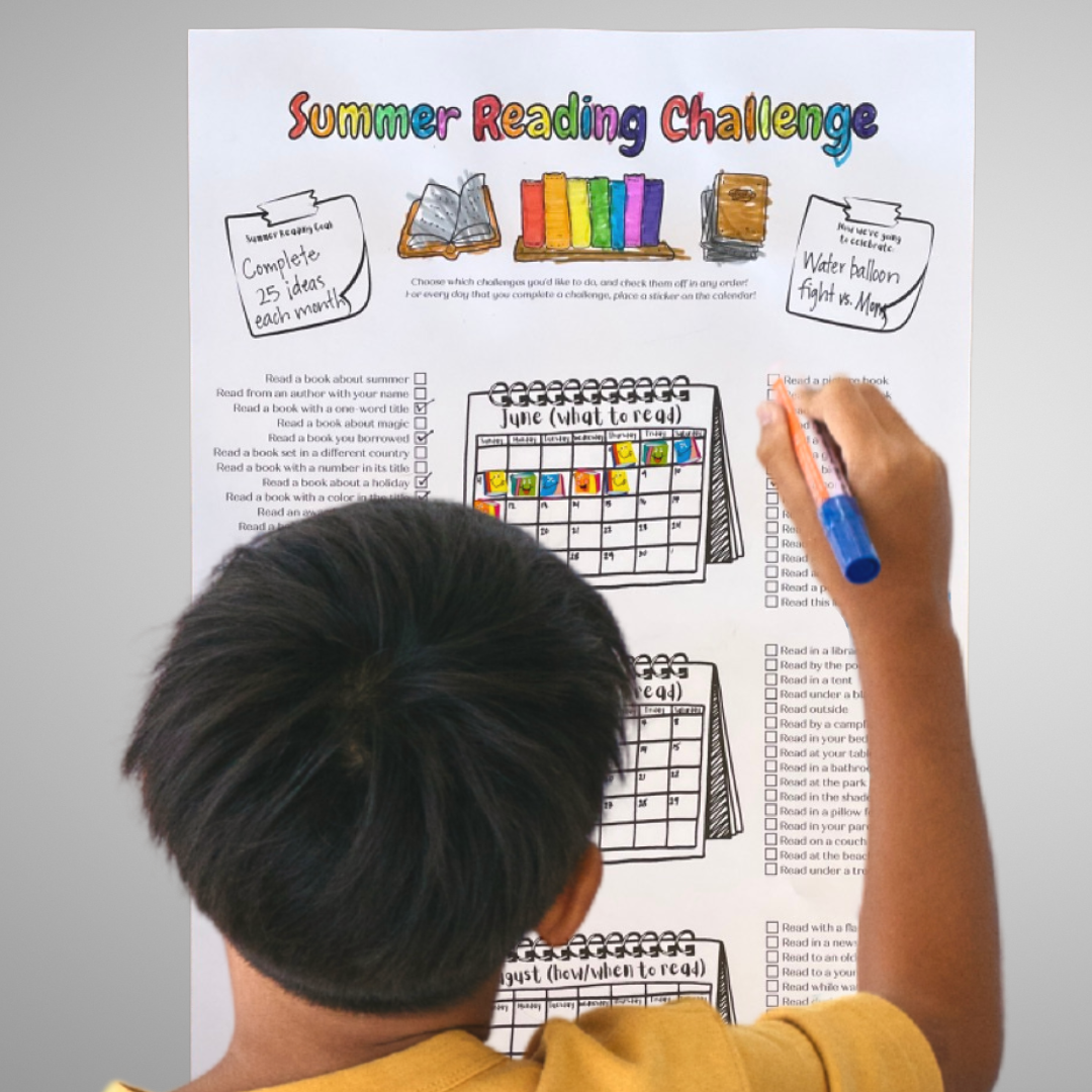 A boy marks off a challenge he completed on the Summer Reading Challenge poster.