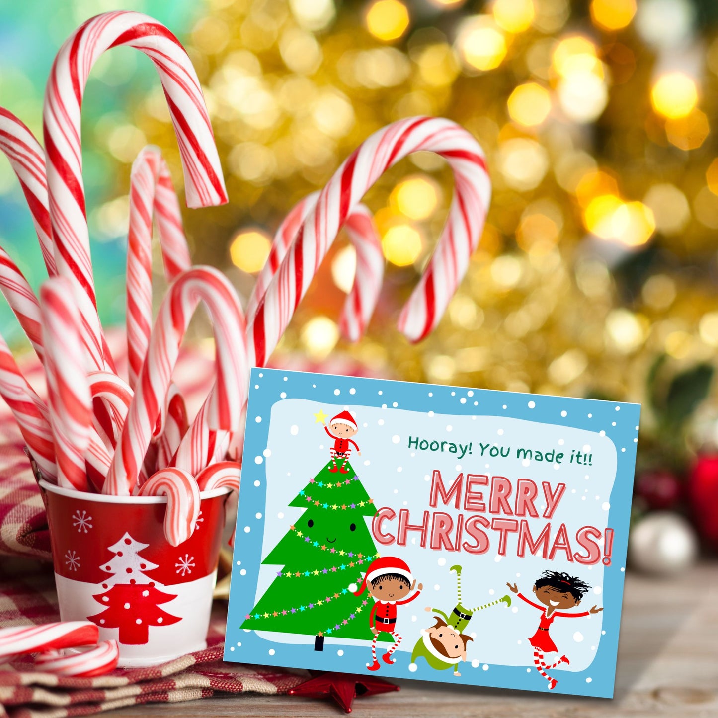 The final card in the Christmas treasure hunt is set-up next to a cup full of candy canes.