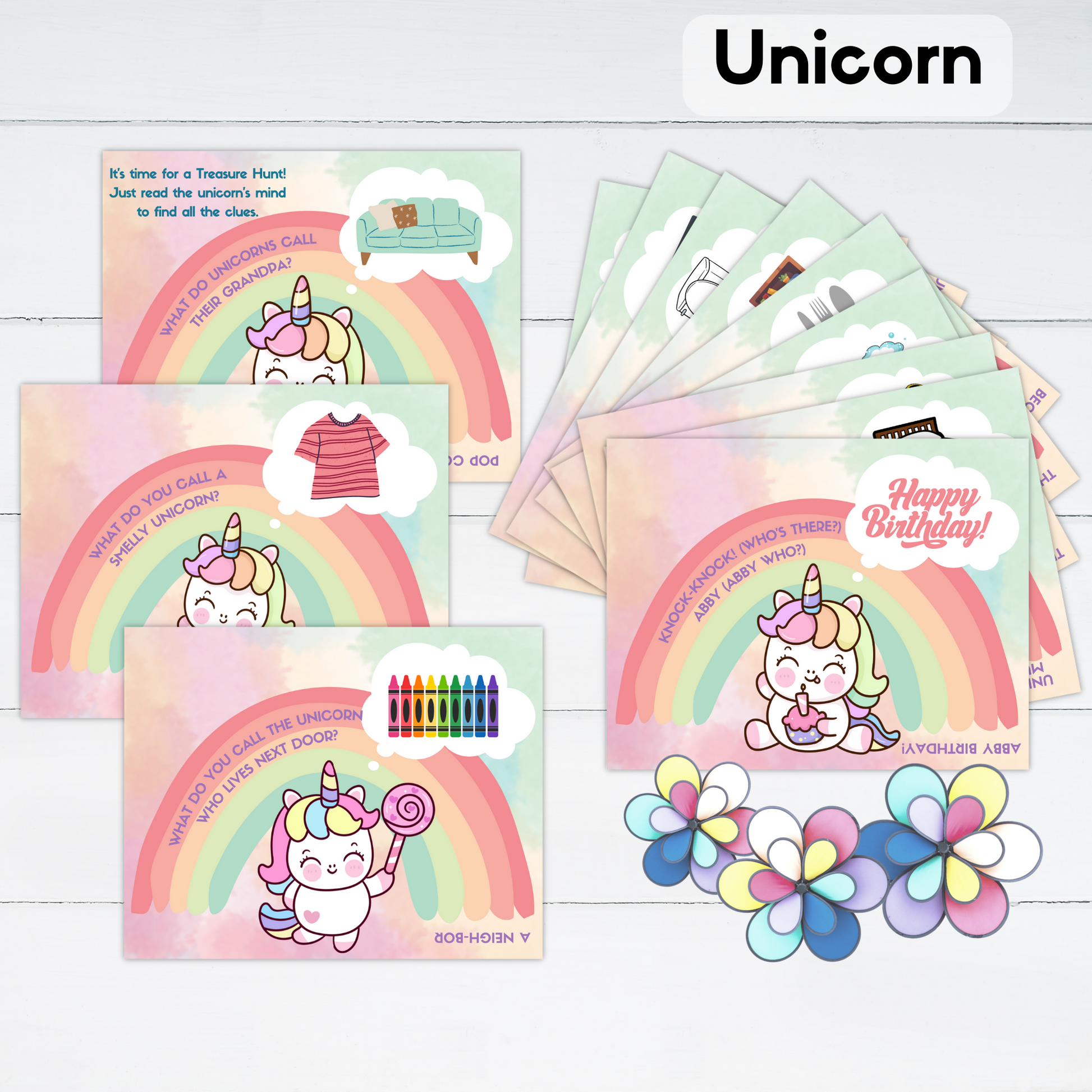 The cards for a unicorn themed treasure hunt are displayed with some flowers.